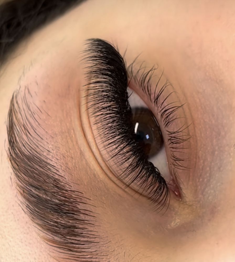 A close up of a woman's eye with long lashes