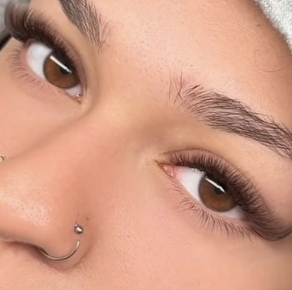 A close up of a person with a nose piercing