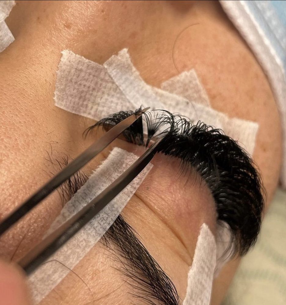 A close up of a persons eye with scissors