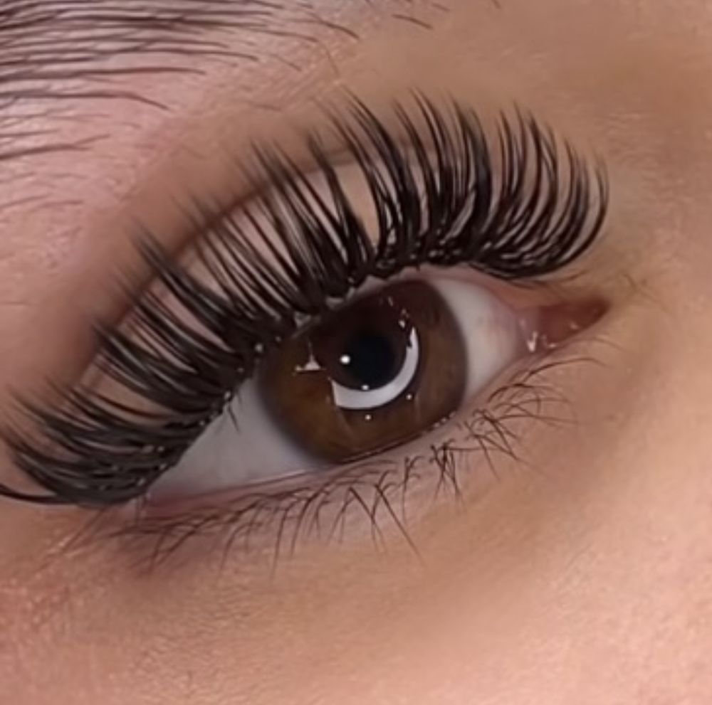 A close up of a woman's eye with long lashes